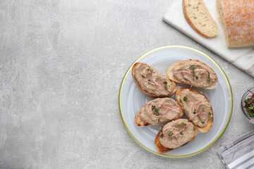 Slices of bread with delicious pate and microgreens on light grey table, flat lay. Space for text - obrazy, fototapety, plakaty