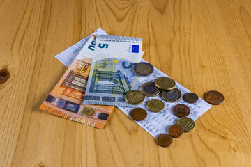 Fototapeta na wymiar catering restaurant concept of cash receipt with euro cash money on a brown table background