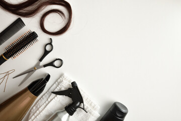 Accessories for hair cutting and styling on white table detail