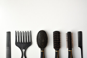 Set of hairbrushes of various uses on white table