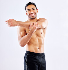 Fototapeta na wymiar Always stretch before a workout. Shot of a young man stretching his arms before a workout against a studio background.