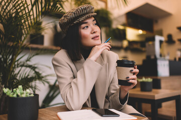 Young millennial asian girl resting in cafe