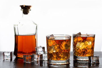 Golden whiskey in glass with ice cubes