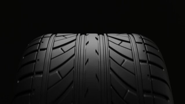 4K Animation. Close up front view on a black car tire in motion cyclic. 3d Render