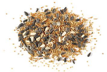 Mixed seeds millet, sunflower and oats pile for exotic birds isolated on white texture, top view