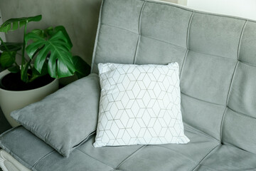 Closeup of pillows on sofa in living room. Concept of interior design.