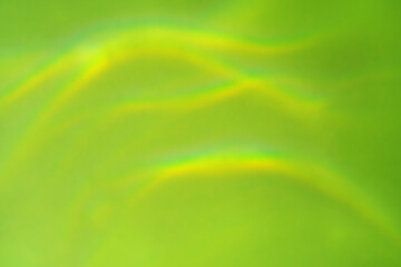 Beautiful lights and shadows of glass on a green background. Overlay mode. Caustic effect of light. Sun hard reflection. Shadows texture. Blurred water backdrop. Top view. Trendy concept