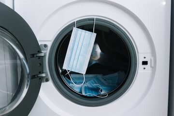 Medical masks in washing machine. Washing machine loading