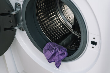 Men's hand clean the washing machine. Detail cleaning concept of washing machine. Stainless drum inside, close-up
