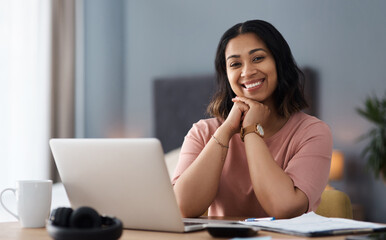 Taking on the day with a smile. Shot of a young woman working from home.