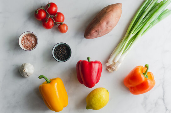 Overhead Flat Lay Of Dinner Meal Prep With Fresh Healthy Vegetables On A White Background