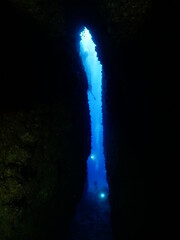 cave diving underwater scuba divers exploring caves and having fun ocean scenery sun beams and rays background