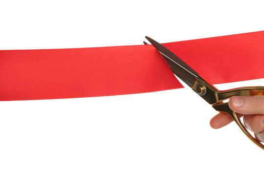 Man cutting red ribbon on white background, closeup