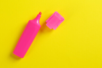 Bright pink marker on yellow background, fat lay. Space for text