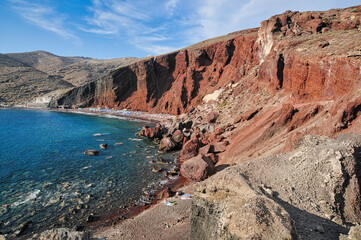 Fototapeta na wymiar View at Red beach volcanic ash sand rock formation on Santorini island in Greece