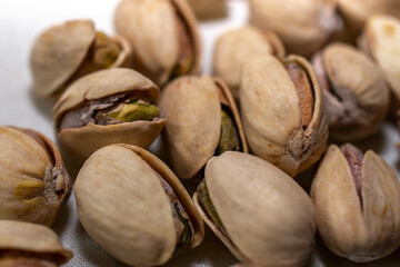 close up of pistachio nuts on a white background 