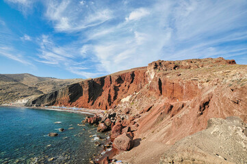 Fototapeta na wymiar View at Red beach volcanic ash sand rock formation on Santorini island in Greece