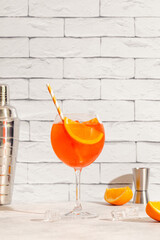 Glass of cold Aperol spritz cocktail.