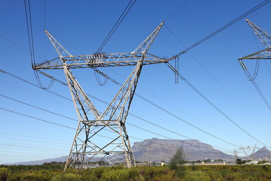 Electric pylons carrying high tension electric cables, near Cape Town in the Western Cape, South Africa.