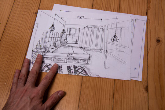 The photo shows sketches, a design project drawn with pencils on a piece of paper. Drawings, sketches, pencils, stationery on the table.