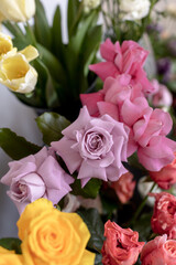 flower shop. Lots of flowers in vases. Purple open roses