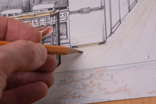 The photo shows sketches, a design project drawn with pencils on a piece of paper. Drawings, sketches, pencils, stationery on the table.