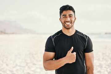 I changed my lifestyle and it changed my life. Shot of a sporty young man showing thumbs up while out for a workout.
