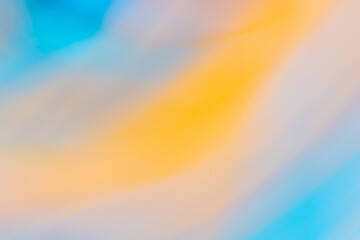 Yellow orange blue abstract banner background with slight blur of curves and waves.