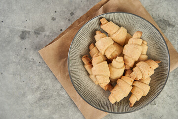 Russian slavic traditional pastry called roguelikes. Cakes bagels. Crispy croissants. Food on grey background, Copy space