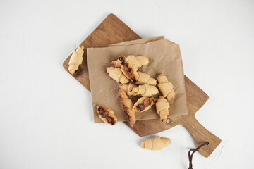 Russian slavic traditional pastry called roguelikes. Cakes bagels. Crispy croissants. Food on white background, Copy space