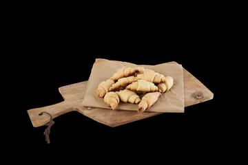 Isolated russian slavic traditional pastry called roguelikes. Cakes bagels. Crispy croissants. Food on black background