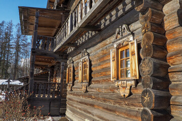 Fototapeta na wymiar Traditional rural wooden building in north Russia. log walls and windows with carved platbands