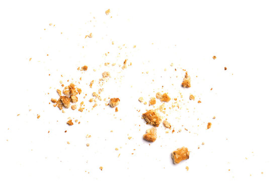 Scattered crumbs of vanilla chip butter cookies isolated on white background. Close-up view of brown crackers. Macro shot of yellow biscuit cake leftovers for your design