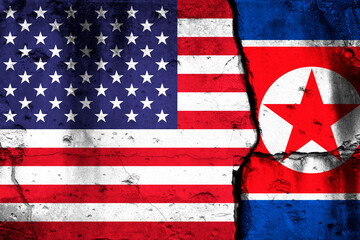 United States and North Korea crisis. Background with national flags on cracked wall photo