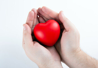 Large red heart in human hands closeup