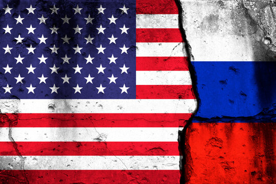 United States and Russia crisis. Background with national flags on cracked wall photo
