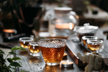 Beautiful chinese tea in teacup with candle flame decoration - obrazy, fototapety, plakaty