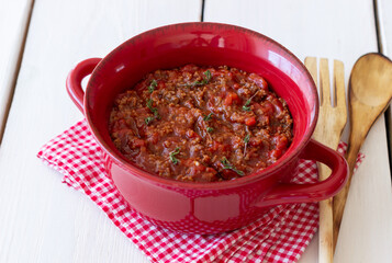 Bolognese sauce on a wooden background. Italian cuisine.