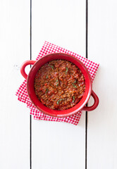 Bolognese sauce on a wooden background. Italian cuisine.