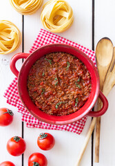 Bolognese sauce on a wooden background. Italian cuisine.