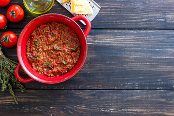 Bolognese sauce on a wooden background. Italian cuisine.