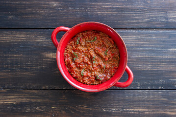 Bolognese sauce on a wooden background. Italian cuisine.