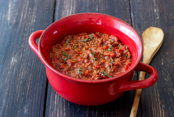 Bolognese sauce on a wooden background. Italian cuisine.