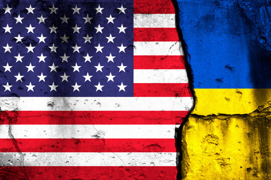 United States and Ukraine crisis. Background with national flags on cracked wall photo