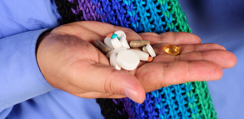 Treatments and healthcare. Man hands with different pills prescribed by doctor. Medicine concept.
