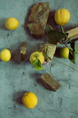 Still Life yellow and green lemons composition in a stone background