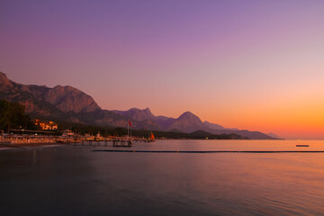 Beautiful sunset near the Mediterranean Sea in Turkey. View of hotels and mountains.