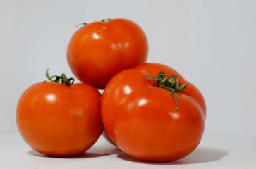 Red tomatoes on a white background