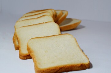Pieces of white bread on a white background