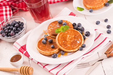 Pancakes with blueberries and chocolate cream.